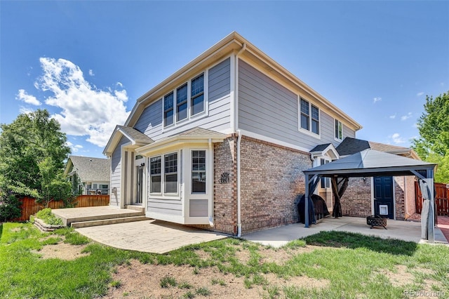 20394 E Colgate Pl, Aurora, CO 80013 - rear view of house featuring a gazebo, brick siding, and a patio area