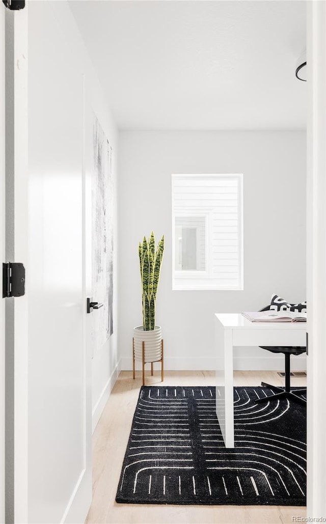 home office featuring wood finished floors and baseboards