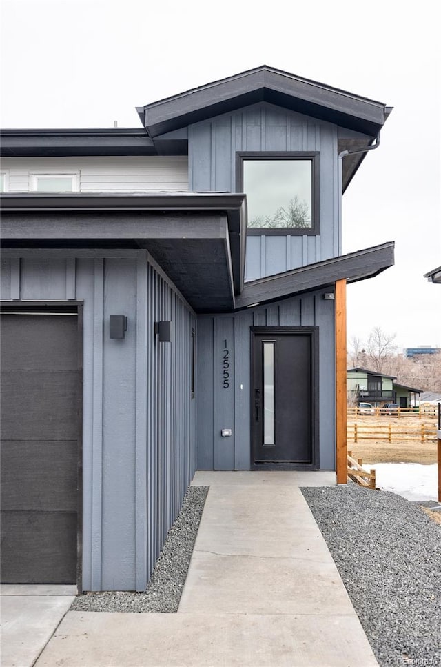 property entrance featuring board and batten siding