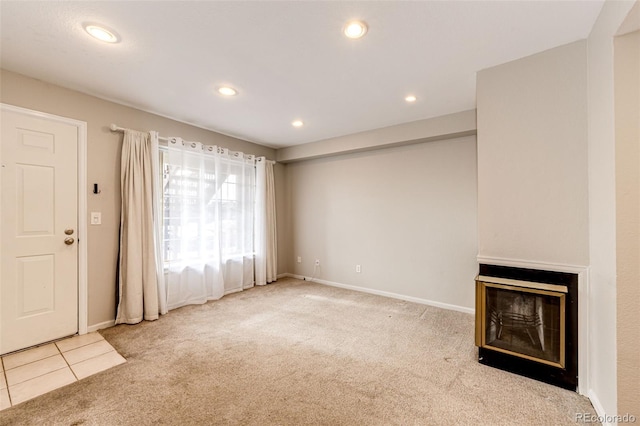 unfurnished living room featuring light carpet