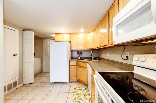 kitchen featuring light tile patterned floors, white appliances, light brown cabinets, and sink