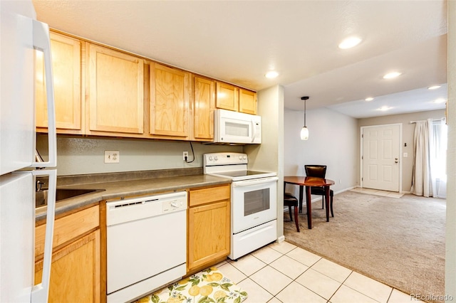 kitchen with light brown cabinetry, hanging light fixtures, light colored carpet, and white appliances