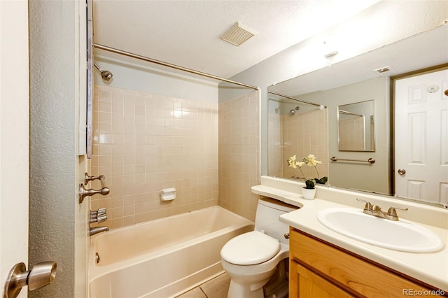 full bathroom featuring tile patterned floors, a textured ceiling, vanity, bathing tub / shower combination, and toilet