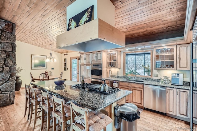 kitchen with a breakfast bar area, appliances with stainless steel finishes, and wooden ceiling