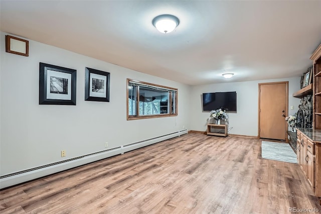 unfurnished living room with light wood finished floors, baseboards, and a baseboard radiator