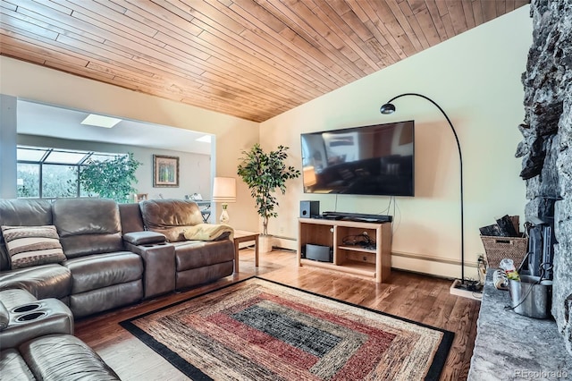 living area featuring lofted ceiling, a baseboard heating unit, wood ceiling, and wood finished floors
