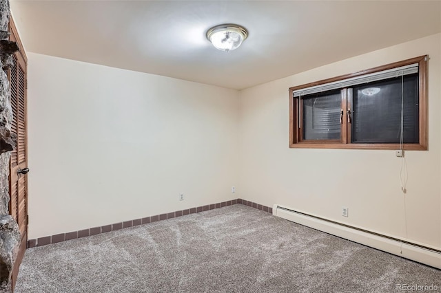 empty room with a baseboard radiator, carpet floors, and baseboards