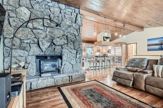 living room with vaulted ceiling, wood ceiling, and wood finished floors