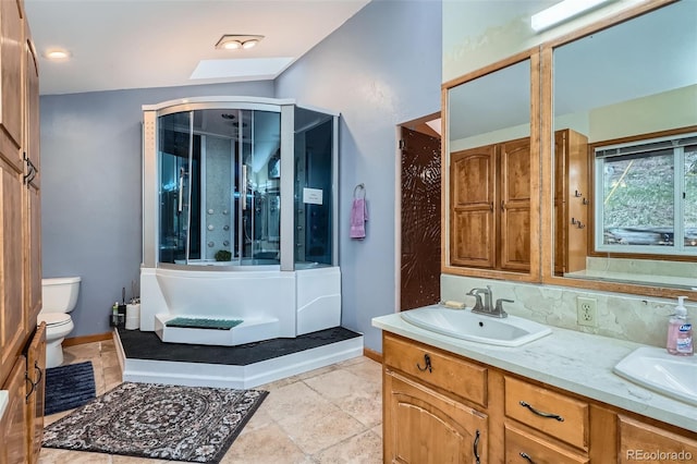 full bath with toilet, baseboards, double vanity, and a sink