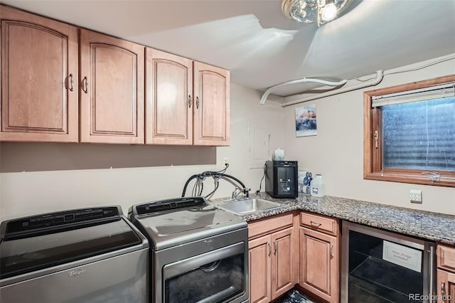 laundry area with separate washer and dryer, laundry area, wine cooler, and a sink