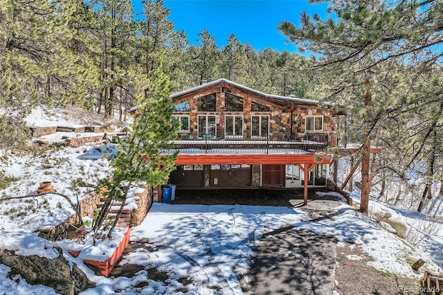 21191 Pleasant Park Rd, Conifer, CO 80433 - view of front facade with stone siding and a deck