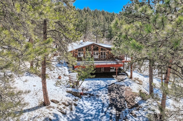 21191 Pleasant Park Rd, Conifer, CO 80433 - snow covered property with a deck and a view of trees
