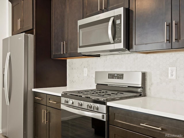 kitchen featuring dark brown cabinetry, backsplash, hardwood / wood-style floors, and appliances with stainless steel finishes