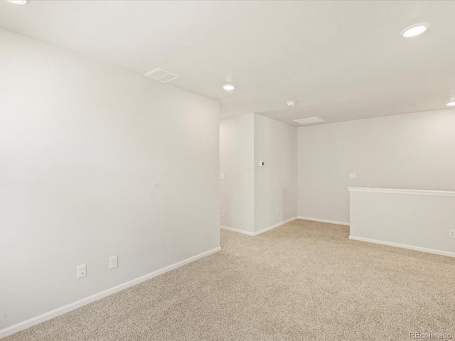 unfurnished room featuring light carpet