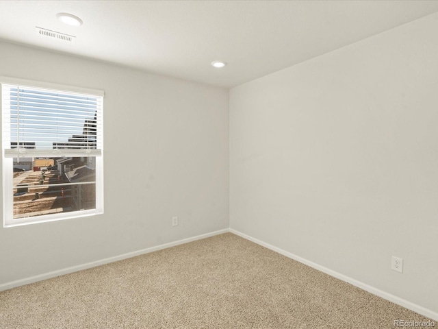 unfurnished room featuring carpet