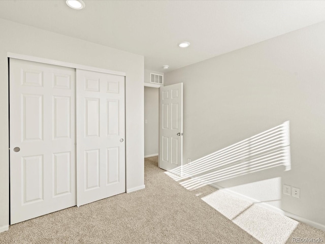 unfurnished bedroom with a closet and carpet