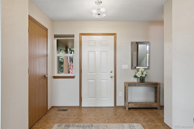 5040 Sweetgrass Ln, Colorado Springs, CO 80922 - entrance foyer featuring a textured ceiling and tile patterned floors