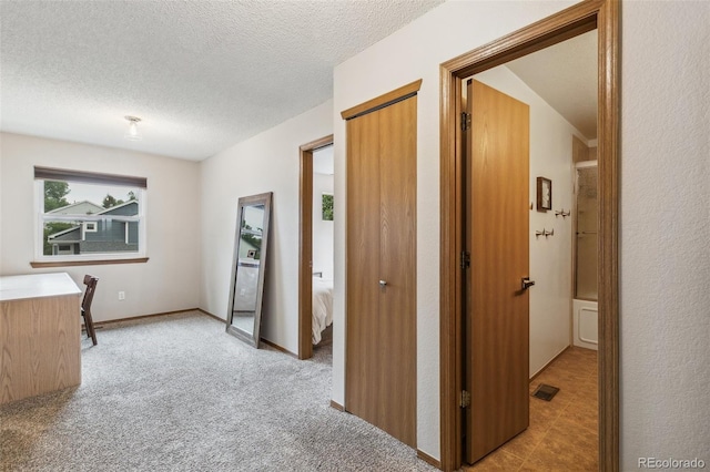 5040 Sweetgrass Ln, Colorado Springs, CO 80922 - hallway with a textured ceiling and light colored carpet