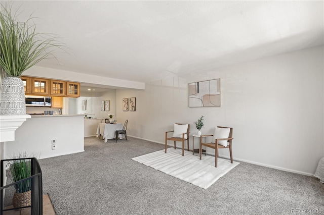 sitting room with light carpet and baseboards