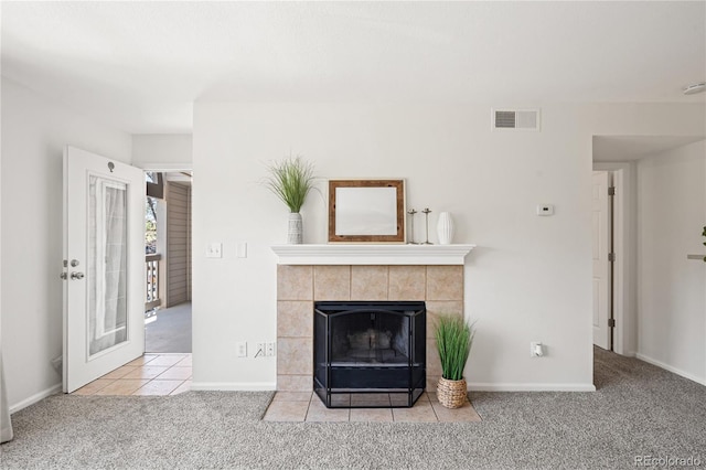 unfurnished living room with carpet, a fireplace, and baseboards