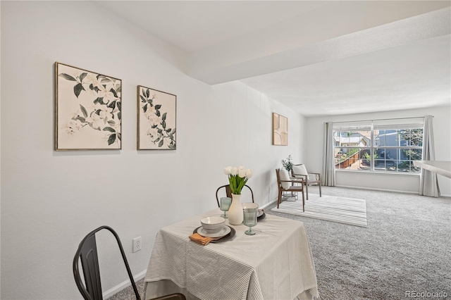 carpeted dining room with baseboards