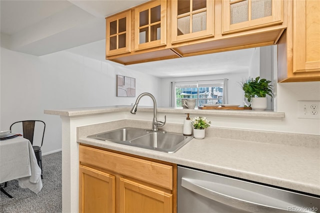 kitchen featuring stainless steel dishwasher, a sink, light countertops, carpet flooring, and glass insert cabinets