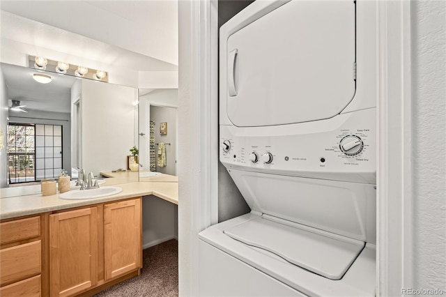 laundry area featuring stacked washer / dryer, a sink, and carpet