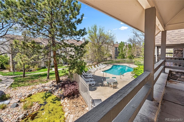 view of pool with a patio and fence