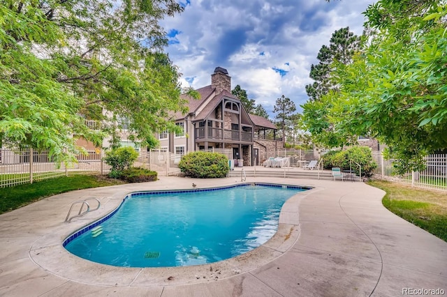 view of pool featuring a patio and fence