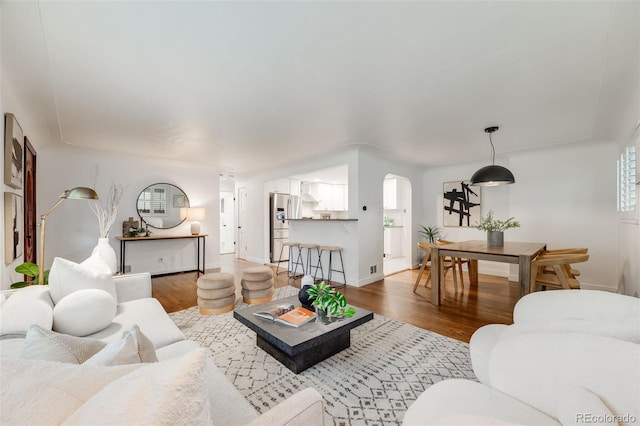 2090 Irving St, Denver, CO 80211 - living room featuring wood finished floors, arched walkways, and baseboards