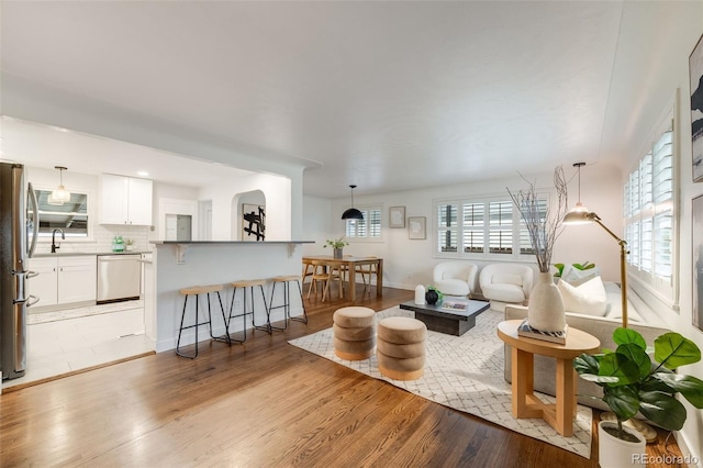 2090 Irving St, Denver, CO 80211 - living area with light wood-type flooring and baseboards