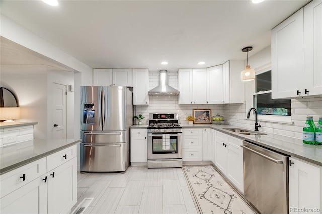 2090 Irving St, Denver, CO 80211 - kitchen featuring appliances with stainless steel finishes, wall chimney range hood, a sink, tasteful backsplash, and recessed lighting