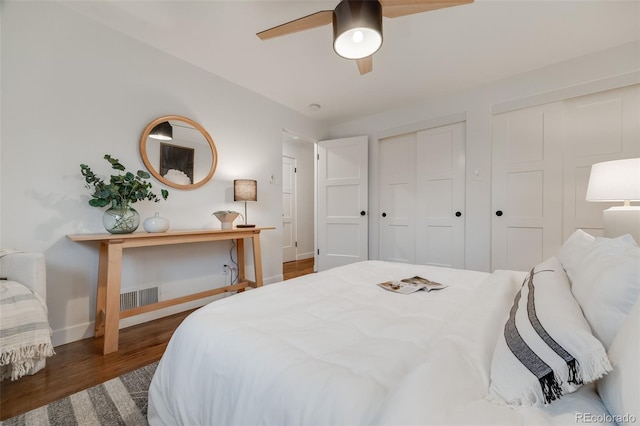 2090 Irving St, Denver, CO 80211 - bedroom featuring baseboards, wood finished floors, two closets, and a ceiling fan