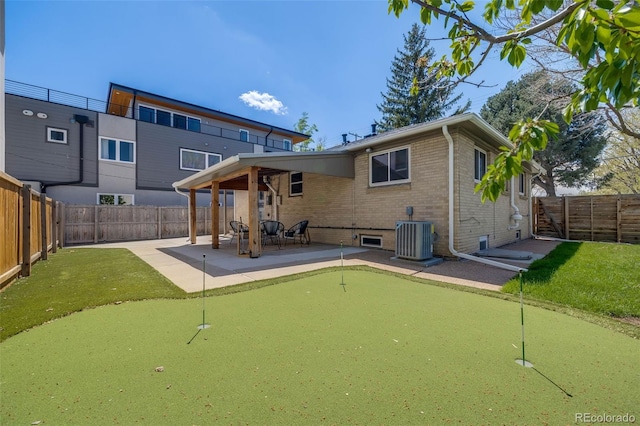 2090 Irving St, Denver, CO 80211 - rear view of property with an area to practice putting, a patio, brick siding, and central air condition unit