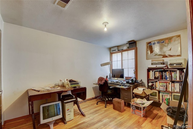 6805 Marshmerry Ln, Evergreen, CO 80439 - home office with wood finished floors and a textured ceiling