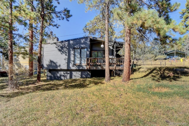 6805 Marshmerry Ln, Evergreen, CO 80439 - rear view of property with a wooden deck and a yard