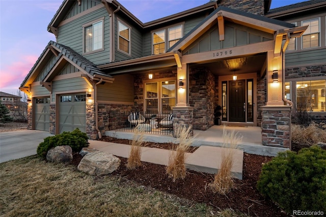 craftsman inspired home with board and batten siding, a porch, and stone siding