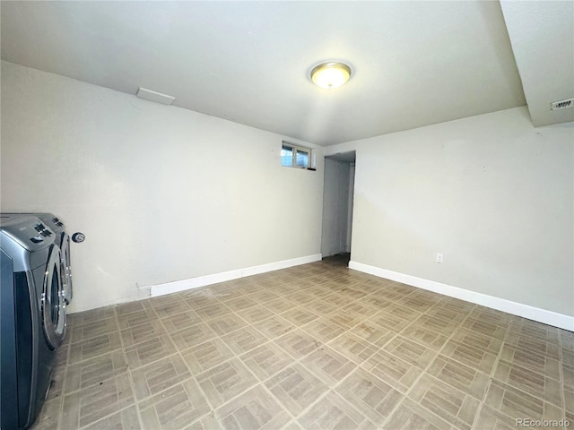 washroom with baseboards, laundry area, and washer and clothes dryer