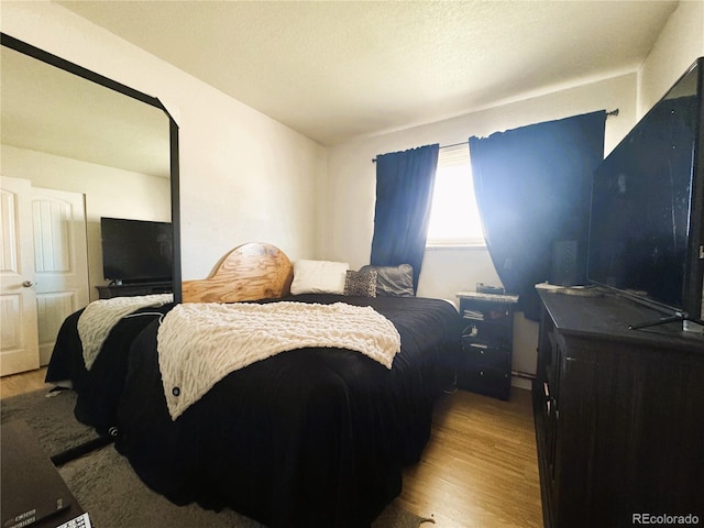 bedroom featuring wood finished floors