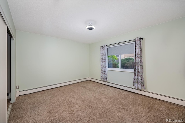 carpeted empty room featuring a baseboard radiator