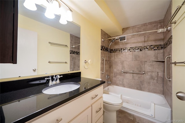 full bathroom with vanity, tiled shower / bath, tile patterned floors, and toilet