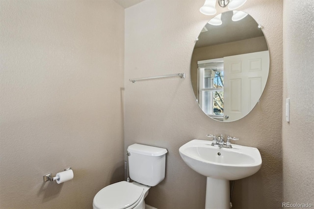 bathroom featuring toilet and sink