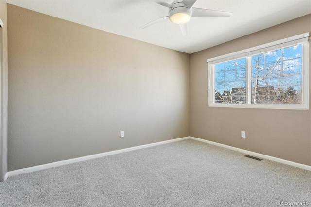 carpeted empty room featuring ceiling fan