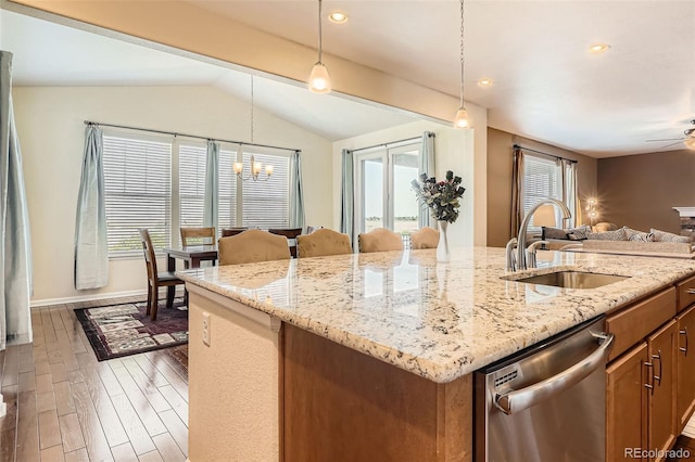 25561 E 5th Pl, Aurora, CO 80018 - kitchen with dishwasher, a sink, open floor plan, a center island with sink, and vaulted ceiling