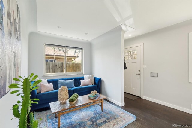 living area with baseboards, recessed lighting, and wood finished floors
