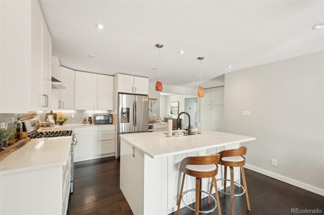 kitchen with light countertops, recessed lighting, appliances with stainless steel finishes, and a sink