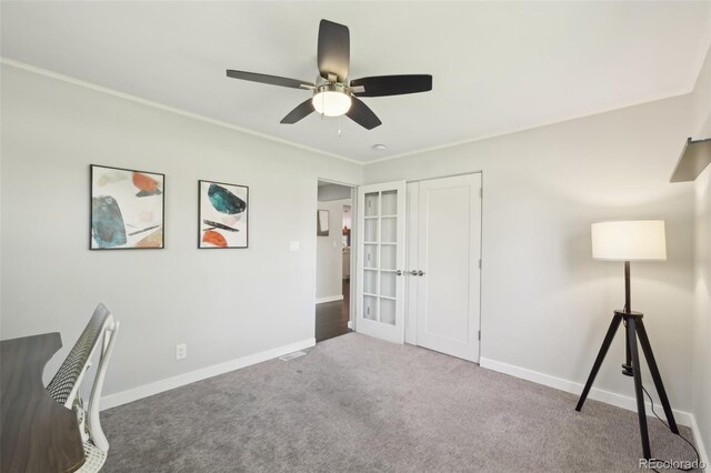 unfurnished office with carpet floors, french doors, a ceiling fan, baseboards, and visible vents