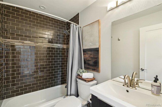 bathroom featuring toilet, shower / bath combo, and vanity