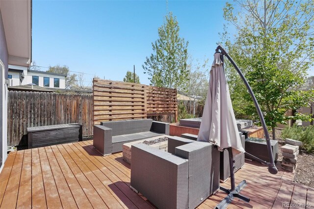 wooden terrace featuring outdoor lounge area