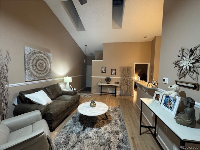 6887 S Dover Way, Littleton, CO 80128 - living room with a skylight, light wood finished floors, and lofted ceiling